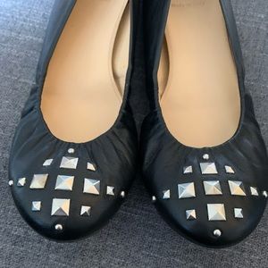 Black j crew flats with silver studs.